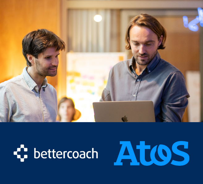 two men looking at a laptop